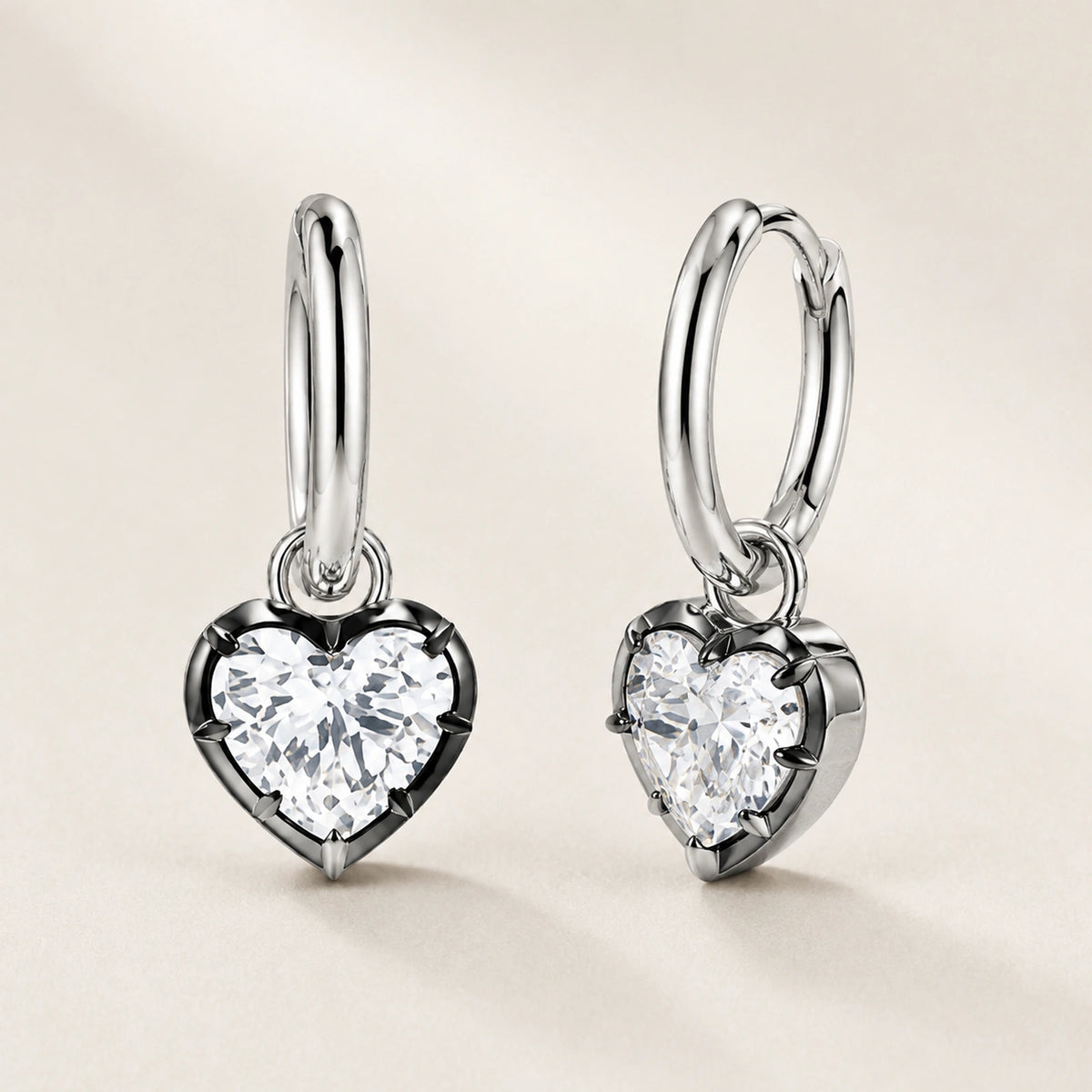 Front and oblique side views of heart crystal huggie hoop earrings