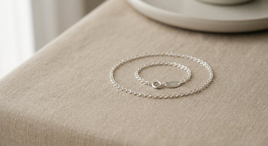 Delicate sterling silver bracelet resting on a neutral surface for a women's sizing guide