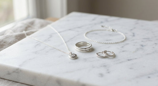 Elegant sterling silver jewelry displayed on a clean neutral surface