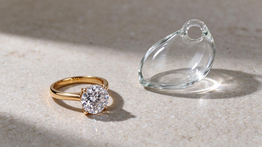 Sparkling cubic zirconia ring and glass jewelry on a neutral surface