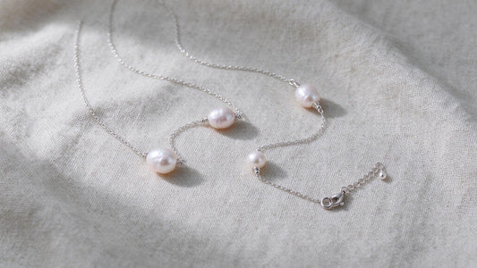 Delicate sterling silver freshwater pearl necklace on a neutral surface