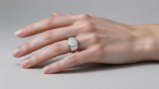 Elegant woman wearing a sterling silver signet ring on her pinky finger