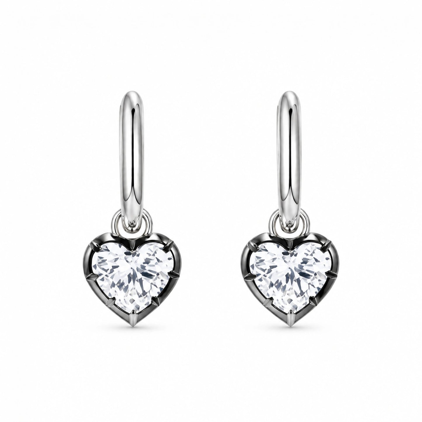 Pair of 925 sterling silver heart crystal huggie hoop earrings on white