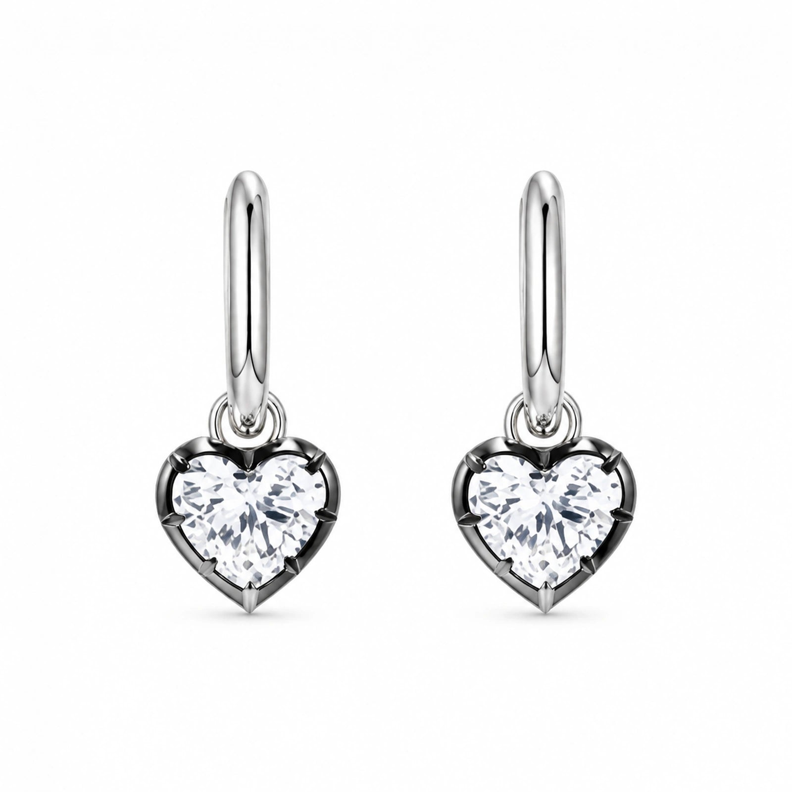 Pair of 925 sterling silver heart crystal huggie hoop earrings on white