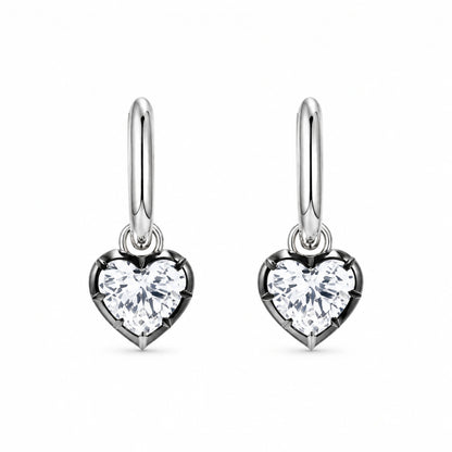 Pair of 925 sterling silver heart crystal huggie hoop earrings on white