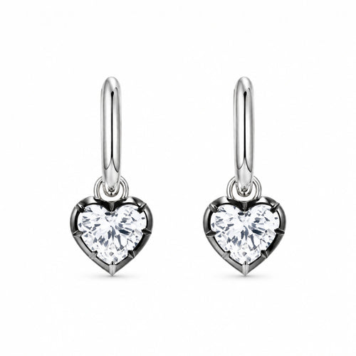 Pair of 925 sterling silver heart crystal huggie hoop earrings on white