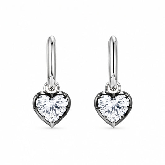 Pair of 925 sterling silver heart crystal huggie hoop earrings on white