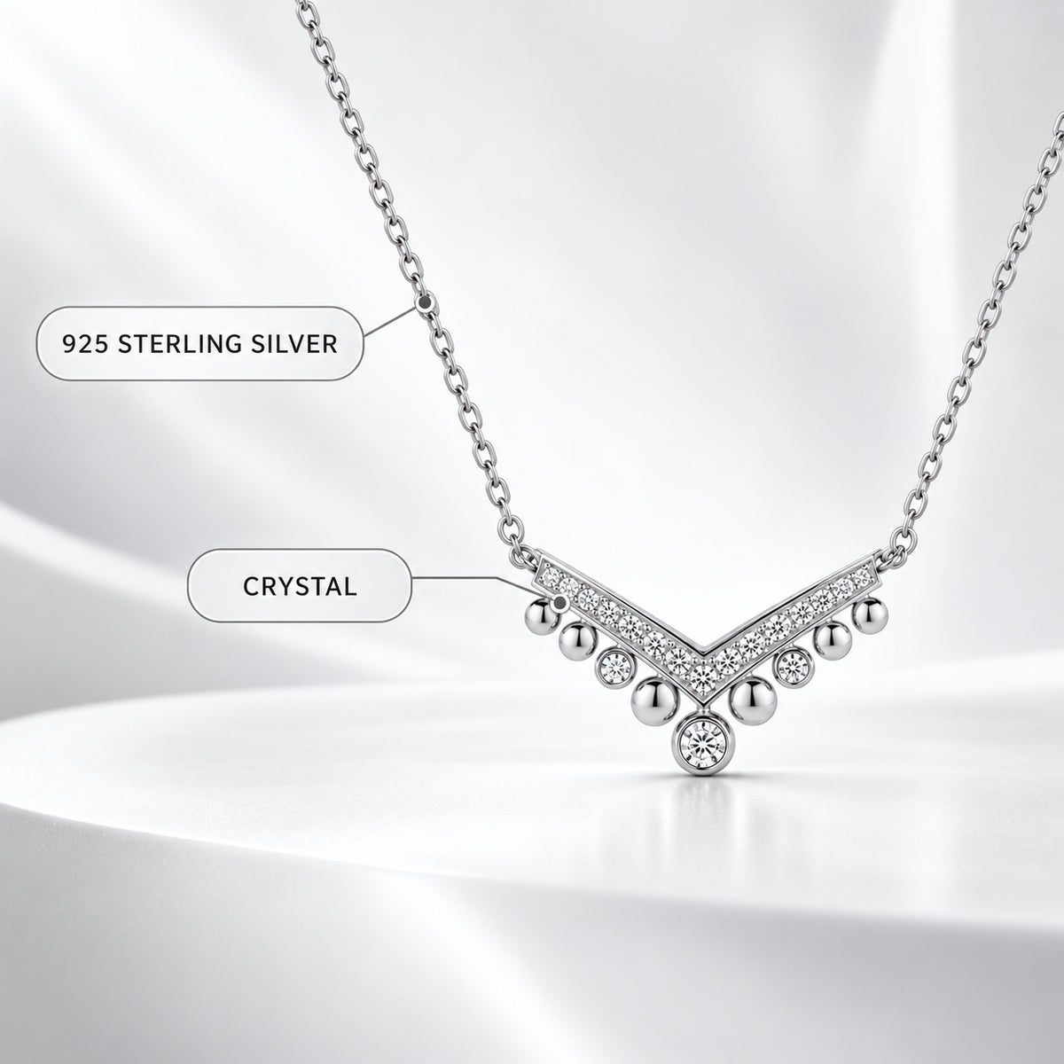 925 sterling silver and crystal material details of a chevron drop necklace.