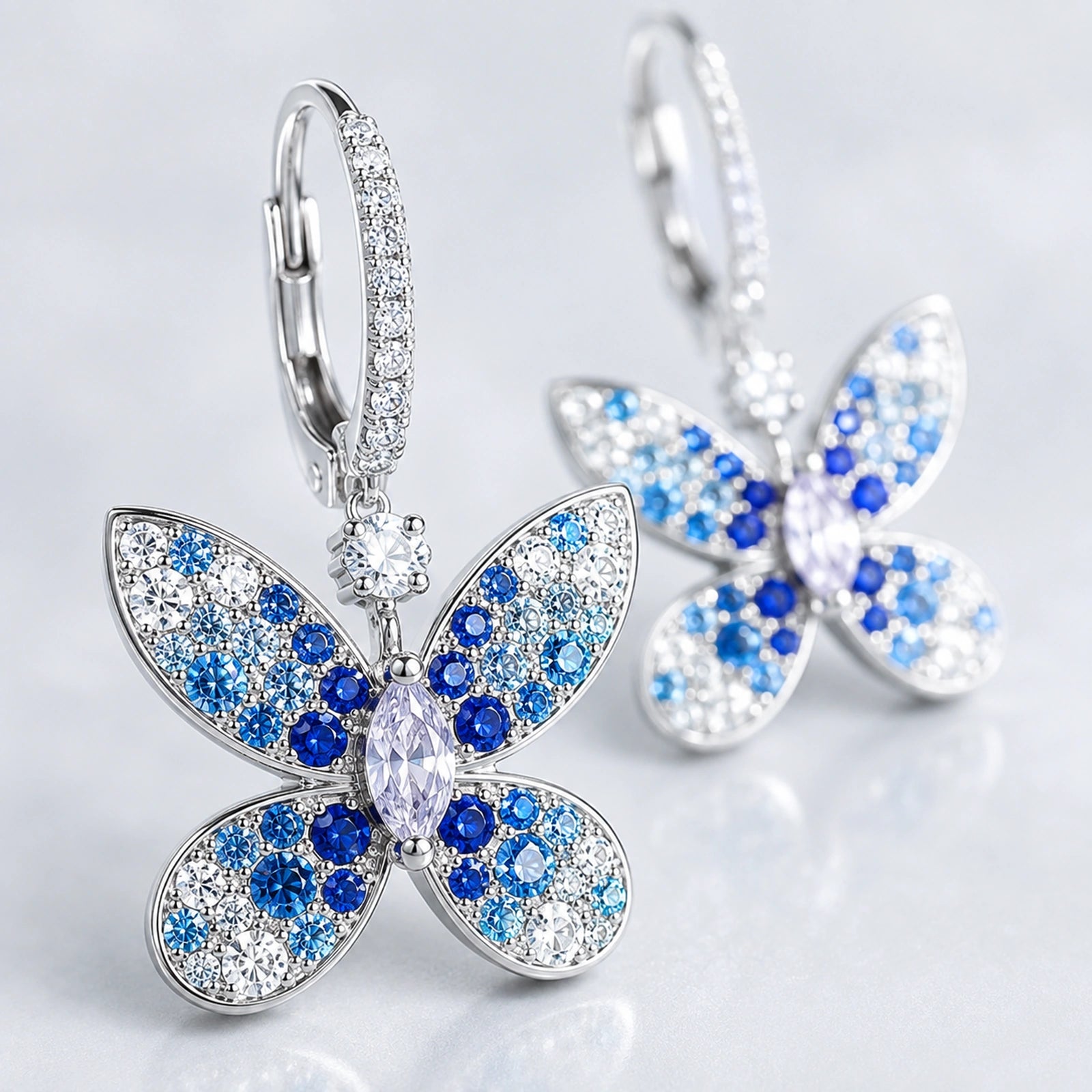 Macro close-up of blue and clear stone accents on four-wing butterfly earrings