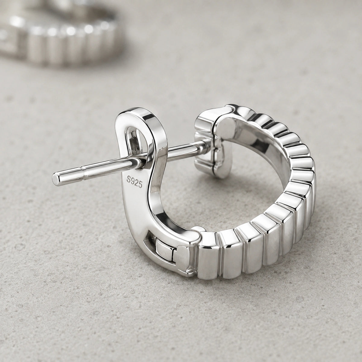 Close-up of polished ribs, post, latch, and S925 earring mark