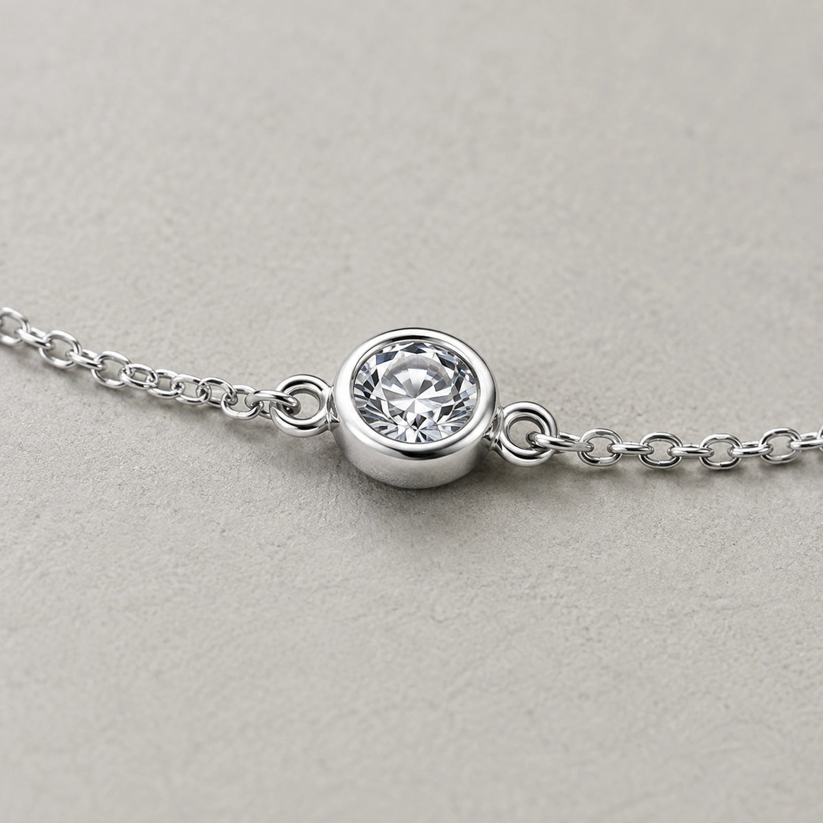 Close-up of the round white crystal in a silver bezel-style setting