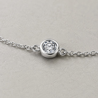 Close-up of the round white crystal in a silver bezel-style setting
