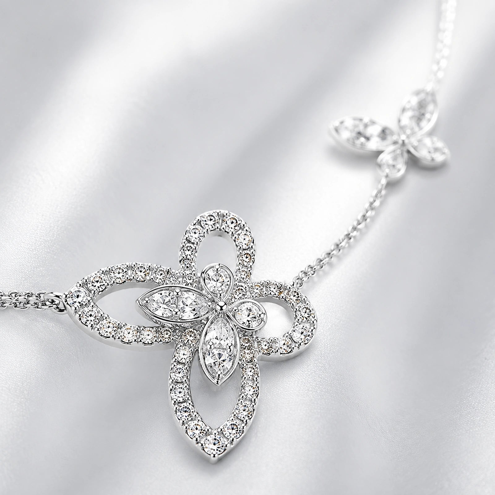 Macro detail of crystal butterfly motif and sterling silver chain