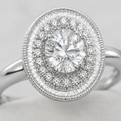 Close-up of the clear faceted center stone, halo and beaded oval border