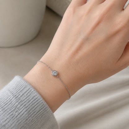 Delicate solitaire crystal bracelet worn close up on the wrist