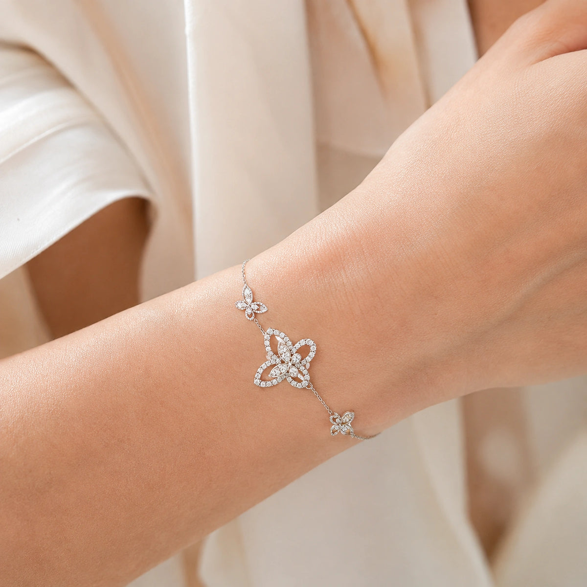 Woman wearing crystal butterfly station sterling silver bracelet close up