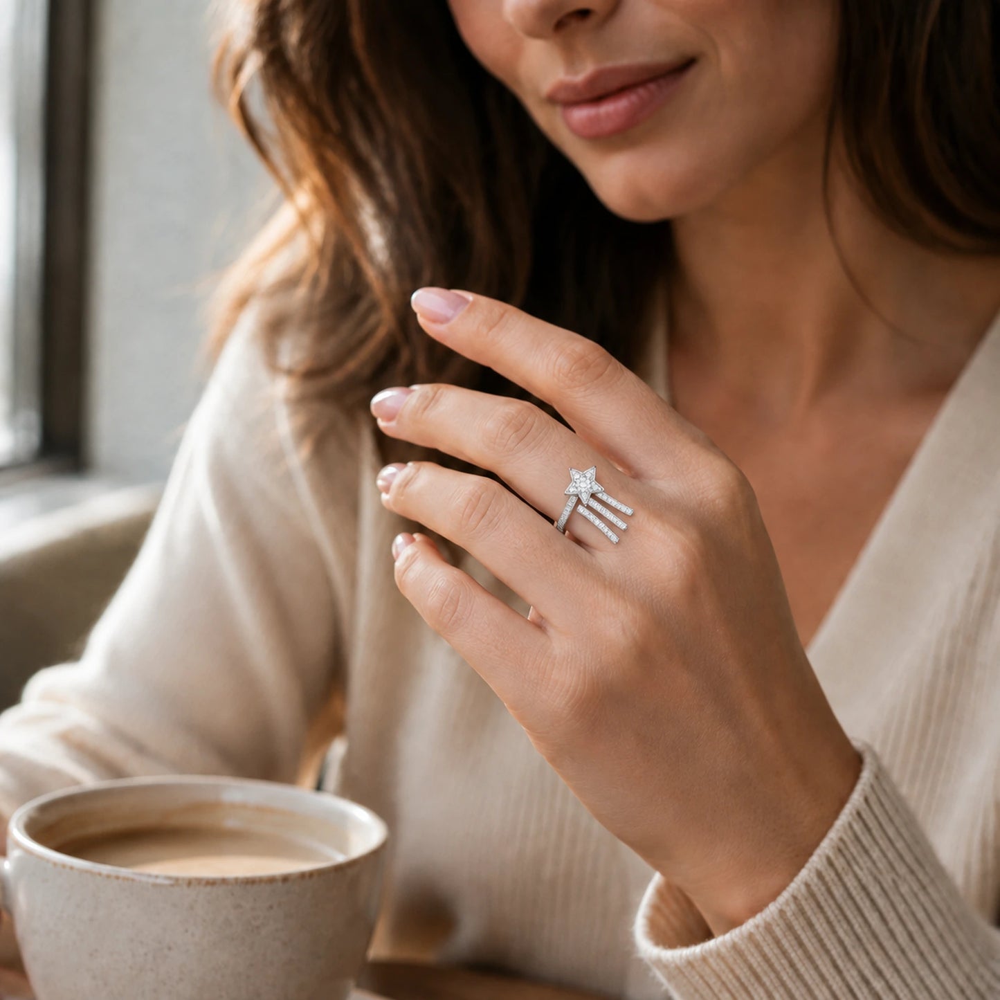 Woman wearing a silver shooting star ring in a cafe setting