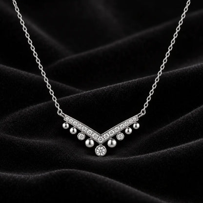 Silver crystal chevron drop necklace displayed on black velvet.