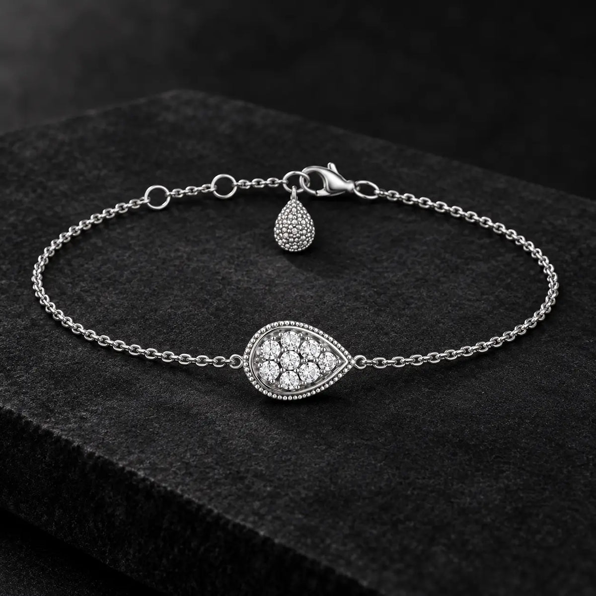 925 silver crystal teardrop bracelet displayed on a premium dark background.