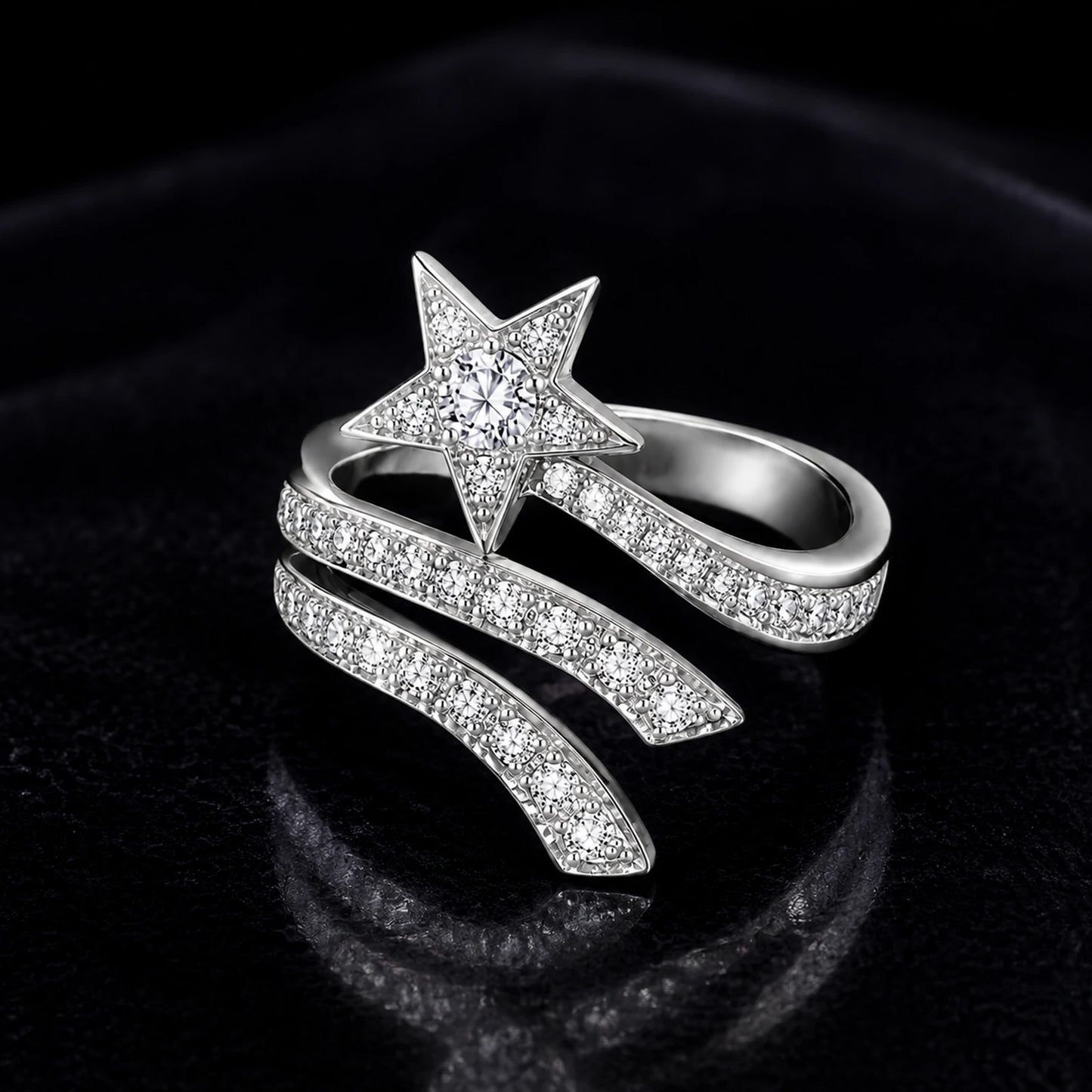 Silver shooting star wrap ring on a dark velvet background