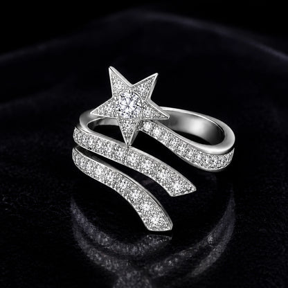 Silver shooting star wrap ring on a dark velvet background