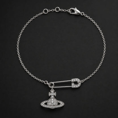 Silver-tone safety pin orb charm bracelet displayed on a dark studio background.
