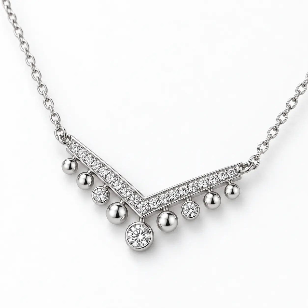 Shallow angled view showing the profile of a silver crystal chevron necklace.