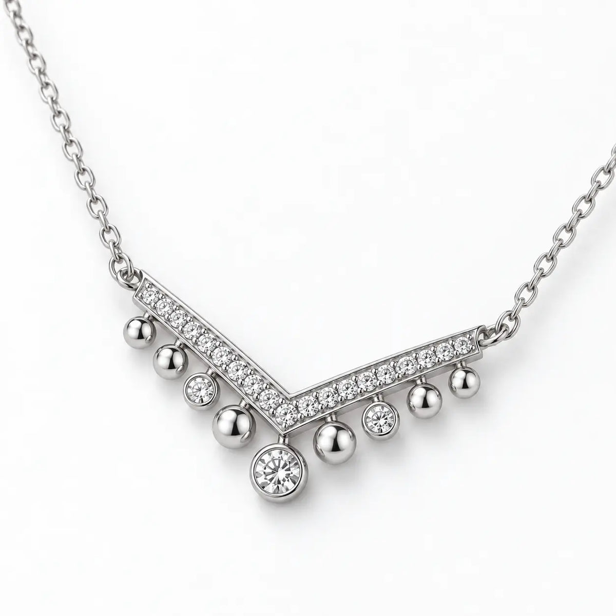Shallow angled view showing the profile of a silver crystal chevron necklace.