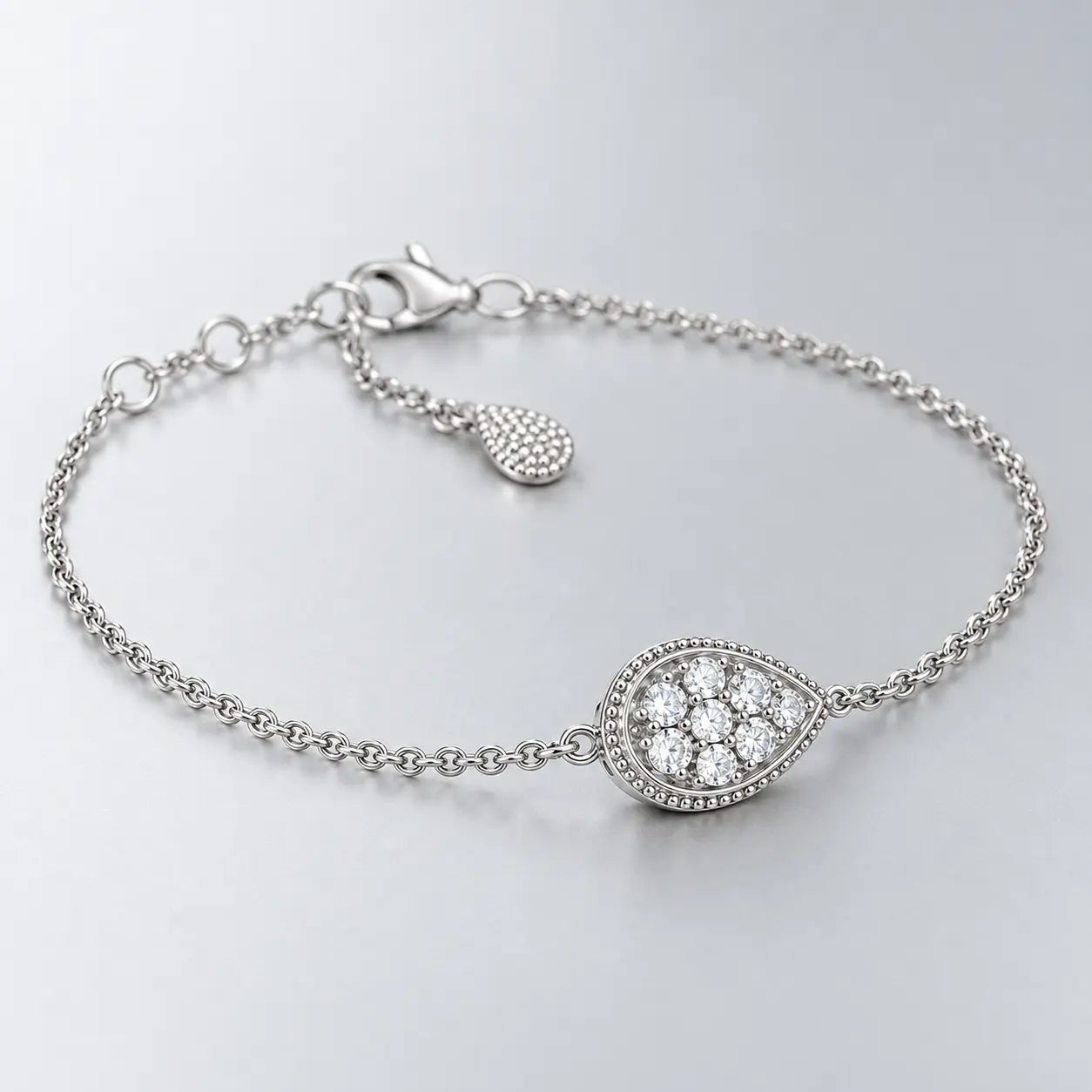 Shallow side-angle view of the silver crystal teardrop bracelet and fine chain.
