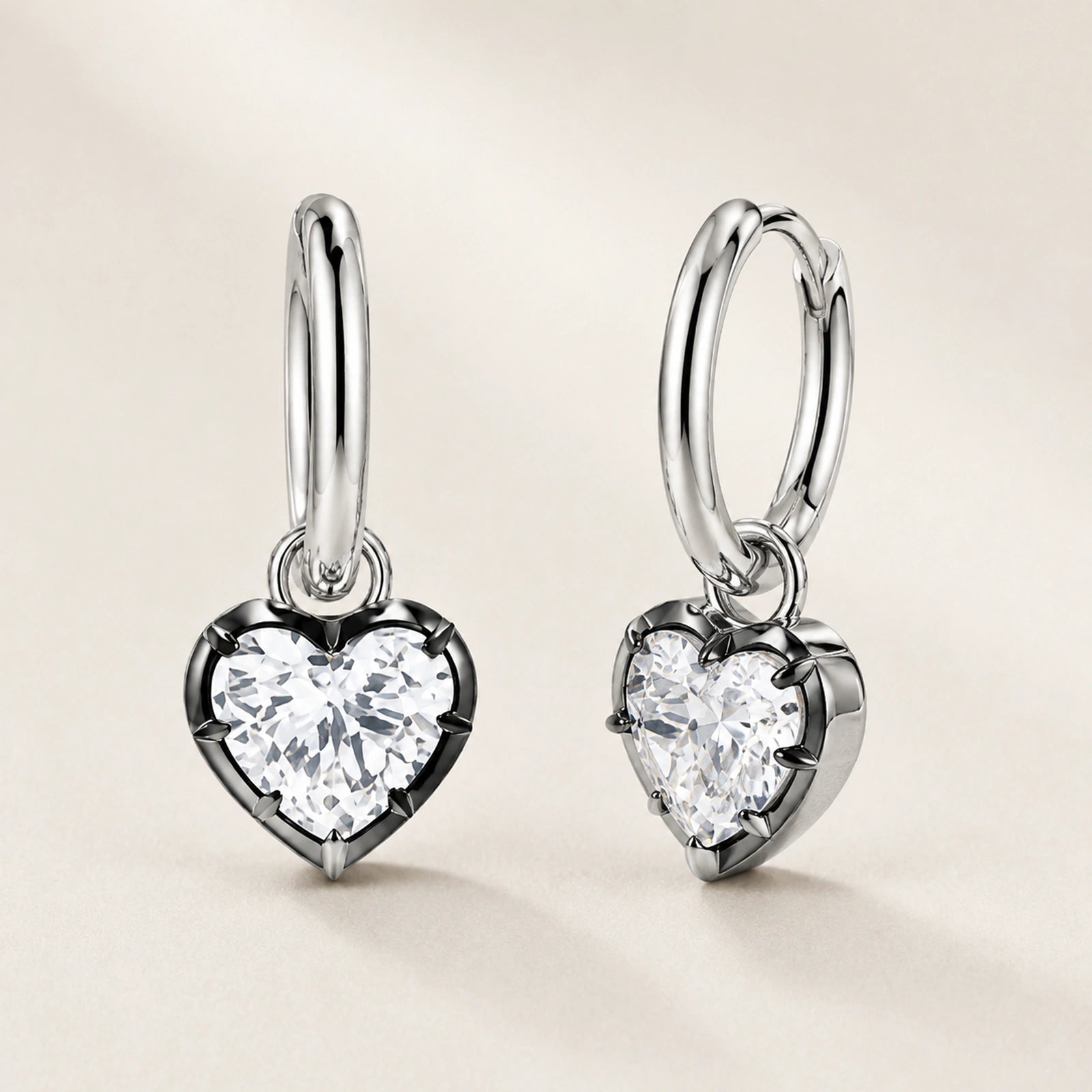 Front and oblique side views of heart crystal huggie hoop earrings