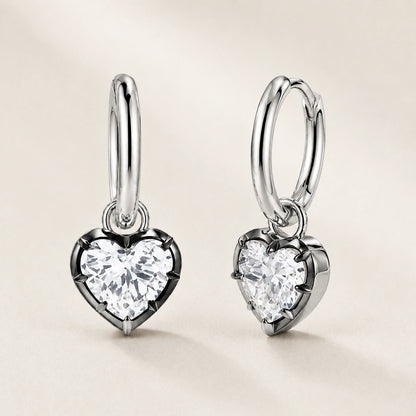 Front and oblique side views of heart crystal huggie hoop earrings