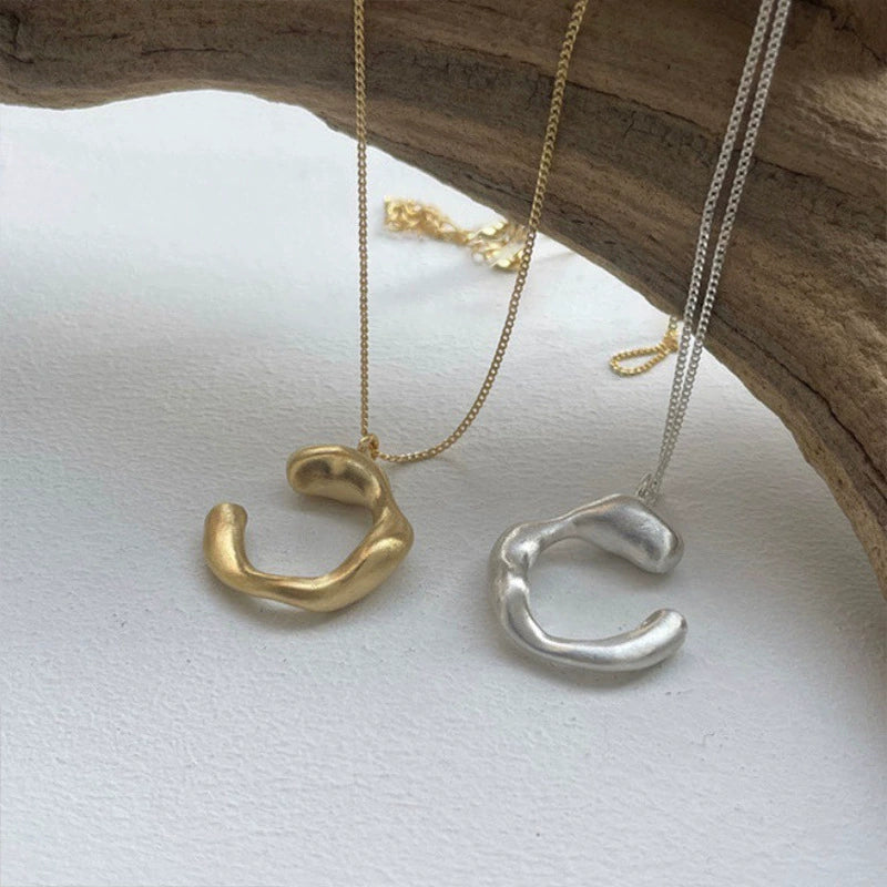 Open curve S925 silver necklace shown from a second angle with a brushed texture