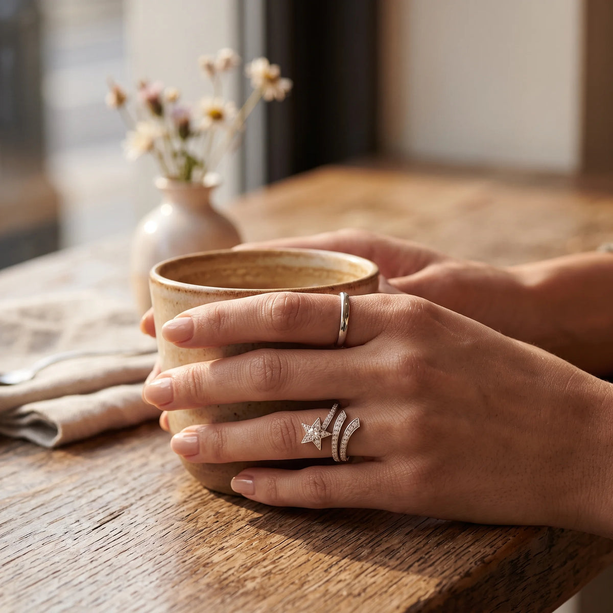 Shooting star wrap ring worn while holding a coffee cup